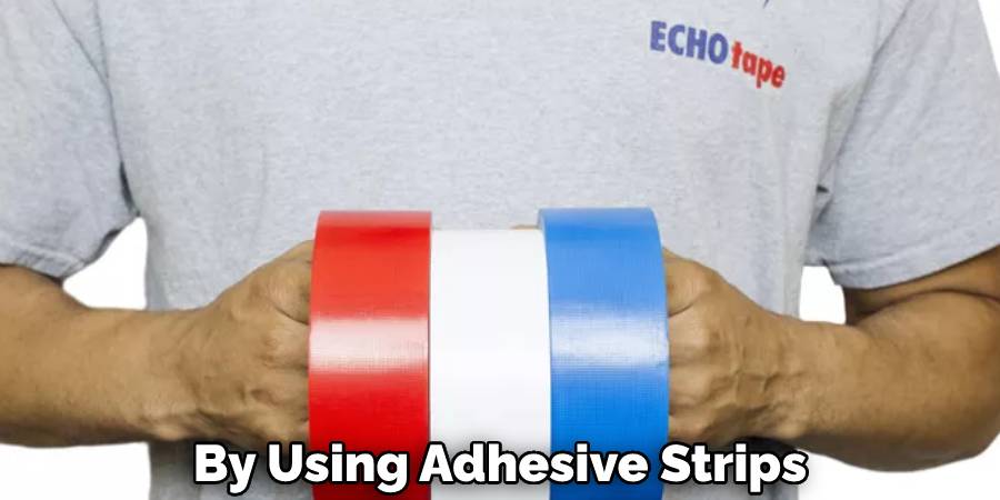 By Using Adhesive Strips
