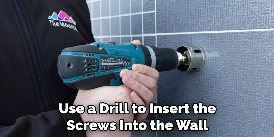 Use a Drill to Insert the Screws Into the Wall